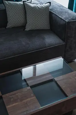 a glass coffee table with a brown couch at \u30a2\u30d0\u30f4\u6e0b\u8c37\u30d3\u30eb2\u968e in Tokyo