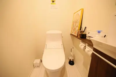 a bathroom with a white toilet and a sink at Ikebukuro Infinity Grove Villa in Tokyo