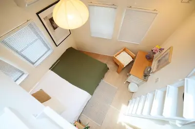 an overhead view of a living room with a table and windows at Ikebukuro Infinity Grove Villa in Tokyo