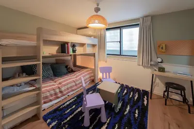 a small bedroom with a bunk bed and a desk at Shinjuku 'The Wizard of Oz' Villa in Tokyo