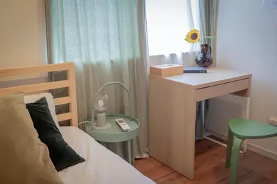 a bedroom with a bed and a desk and a table at Shinjuku 'The Wizard of Oz' Villa in Tokyo