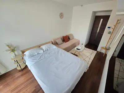 a bedroom with a white bed and a couch at Suke Home Oshiage in Tokyo