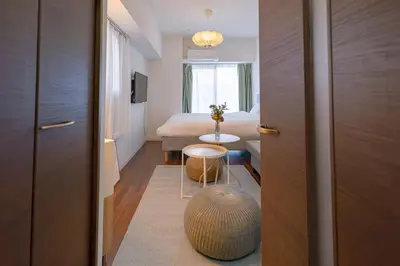 a room with a bed and a table in a room at Suke Home Oshiage in Tokyo