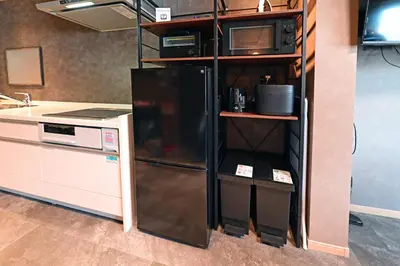 a kitchen with a black refrigerator in a shelf at Rakuna Inn \u8679 Oshiage2 in Tokyo