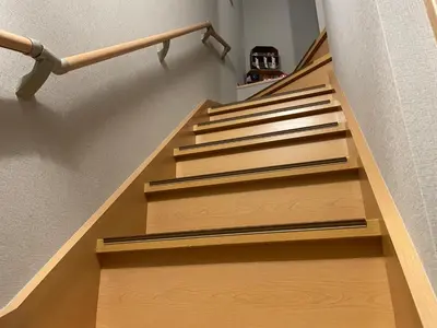 a stairwell with wooden steps and a railing at Rakuna Inn \u8679 Oshiage2 in Tokyo