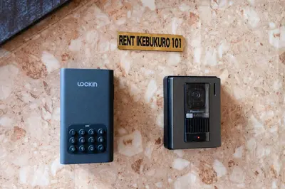 a cell phone sitting on a counter next to a sign at RENTO Ikebukuro 101 in Tokyo