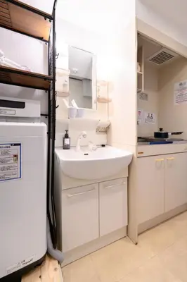 a kitchen with a sink and a refrigerator at RENTO Ikebukuro 301 in Tokyo
