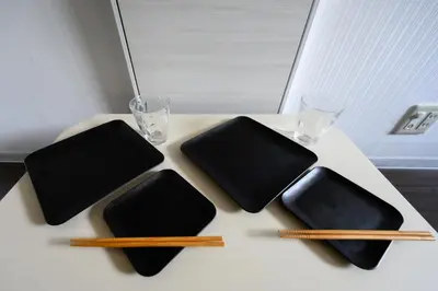 a table with four chopsticks on a table at RENTO Ikebukuro 301 in Tokyo