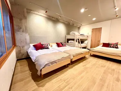 a bedroom with two twin beds and a window at KAMATA EAST and SWEET in Tokyo
