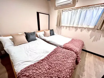 a bedroom with two beds with blankets on them at KAMATA EAST and SWEET in Tokyo