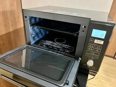 a microwave oven with its door open in a kitchen at KAMATA EAST and SWEET in Tokyo