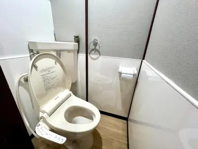 a small bathroom with a toilet with the lid up at KAMATA EAST and SWEET in Tokyo