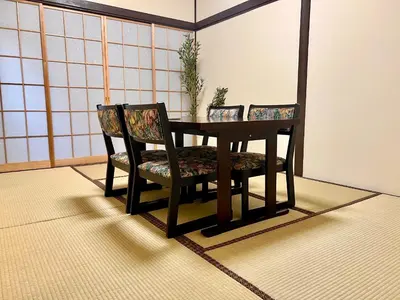 a dining room table with two chairs and a table at KAMATA EAST and SWEET in Tokyo