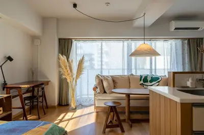a kitchen and living room with a couch and a table at The Apartment Hotel Shibuya 1 in Tokyo