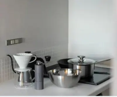 a kitchen with pots and pans on a stove at The Apartment Hotel Shibuya 1 in Tokyo