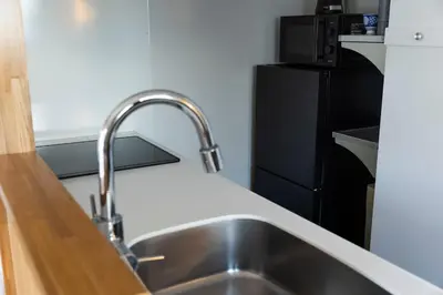 a kitchen with a sink and a counter top at The Apartment Hotel Shibuya 1 in Tokyo