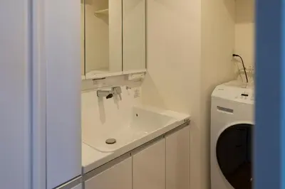 a bathroom with a sink and a washing machine at The Apartment Hotel Yoyogi 1 in Tokyo