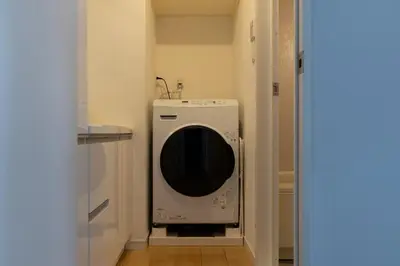 a washer and dryer in a small kitchen at The Apartment Hotel Yoyogi 1 in Tokyo