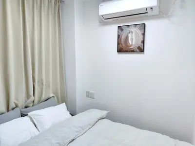a room with a bed and a clock on the wall at Mars Hotel in Tokyo