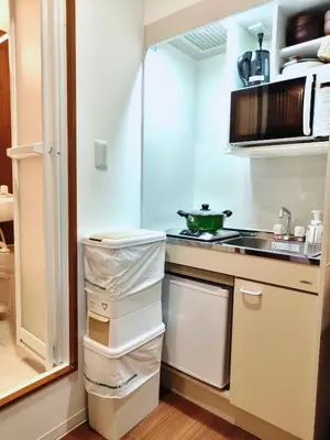 a kitchen with white appliances and a stove top oven at Mars Hotel in Tokyo
