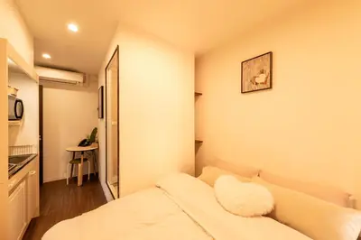 a small room with a bed and a kitchen at Mars Hotel in Tokyo