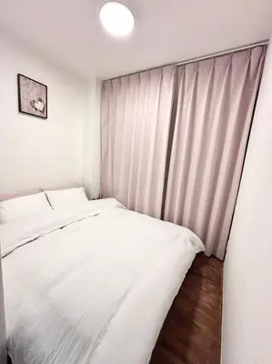 a bedroom with a white bed and a window at Mars Hotel in Tokyo