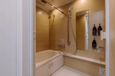 a bathroom with a bath tub and a shower at The Apartment Hotel Ebisu 1 in Tokyo