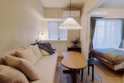 a living room with a couch and a table at The Apartment Hotel Ebisu 1 in Tokyo