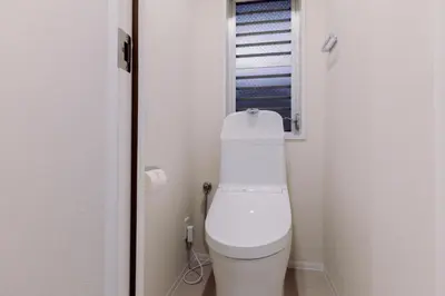 a white toilet in a bathroom with a window at The Apartment Hotel Ebisu 1 in Tokyo