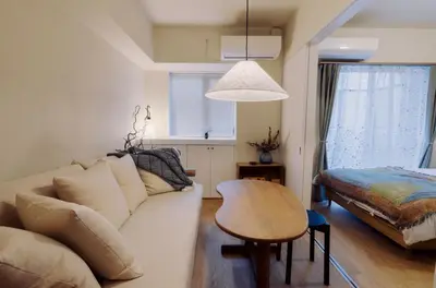 a living room with a couch and a table at The Apartment Hotel Ebisu 1 in Tokyo