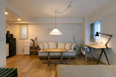 a living room with a couch and a table at The Apartment Hotel Shibuya 2 in Tokyo