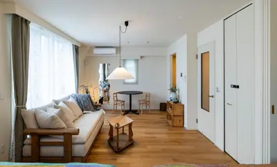 a living room with a white couch and a table at The Apartment Hotel Shibuya 2 in Tokyo