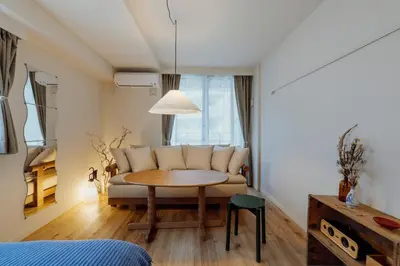 a living room with a couch and a table at The Apartment Hotel Shibuya 2 in Tokyo