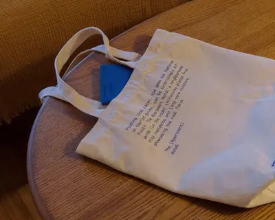 a white bag sitting on top of a table at The Apartment Hotel Shibuya 2 in Tokyo