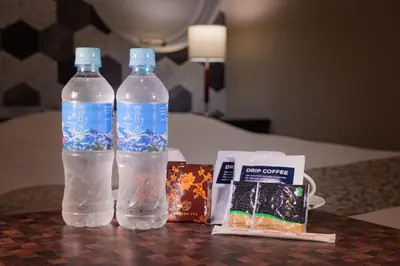 two bottles of water and a book on a table at \u30db\u30c6\u30eb\u30a6\u30a4\u30eb\u30b7\u30c6\u30a3\u6d45\u8349\u672c\u9928 in Tokyo