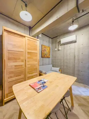 a wooden table in a room with a couch at ideas ASAKUSA Hotel in Tokyo