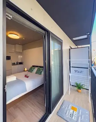 a room with a bed and a sliding glass door at ideas ASAKUSA Hotel in Tokyo