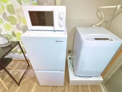 a microwave sitting on top of a refrigerator at 107, Shinjuku City, JR Yamanote Line, 6 min walk to stn in Tokyo