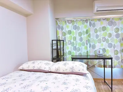 a bedroom with a bed with a table and a window at 107, Shinjuku City, JR Yamanote Line, 6 min walk to stn in Tokyo