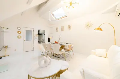 a white living room with a table and chairs at Luxury Tokyo Stay I 120sqm 4LDK I Close to Shibuya & Shinjuku Area in Tokyo