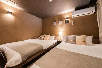 a bedroom with two beds and a air conditioner at Luxury Tokyo Stay I 120sqm 4LDK I Close to Shibuya & Shinjuku Area in Tokyo