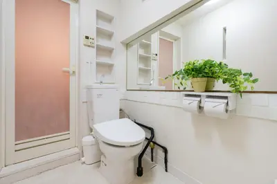 a white bathroom with a toilet and a window at Luxury Tokyo Stay I 120sqm 4LDK I Close to Shibuya & Shinjuku Area in Tokyo