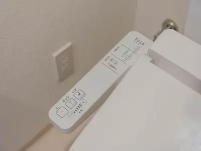 a white remote control sitting on a wall at Artessimo \u62bc\u4e0a402 in Tokyo