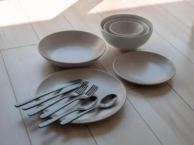 a table with plates and utensils on a floor at Artessimo \u62bc\u4e0a402 in Tokyo