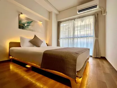 a bedroom with a large bed and a window at Comfy Home Kikukawa in Tokyo