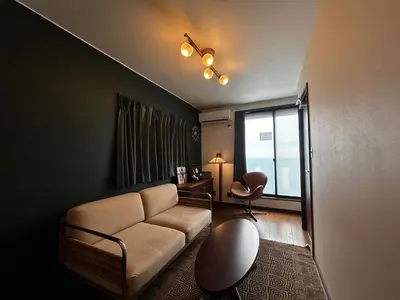 a living room with a couch and a window at \u5317\u6e0b\u8c37inn in Tokyo