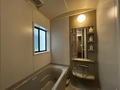 a bathroom with a bath tub and a window at \u5317\u6e0b\u8c37inn in Tokyo
