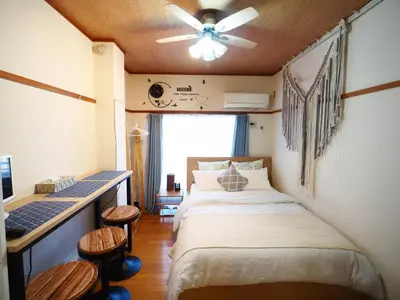 a bedroom with a bed and a ceiling fan at Airport and Disney direct bus Near Koiwa station in Tokyo