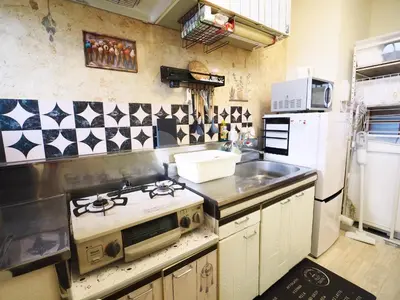 a kitchen with a stove and a sink at Airport and Disney direct bus Near Koiwa station in Tokyo