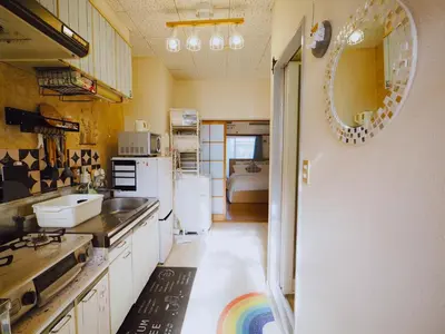 a kitchen with a white refrigerator and a sink at Airport and Disney direct bus Near Koiwa station in Tokyo